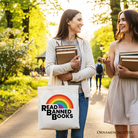 White canvas tote bag by OrnamentallyYou featuring a rainbow design and "Read Banned Books" message, perfect for book lovers.
