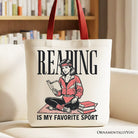 White canvas tote bag with "Reading Is My Favorite Sport" bookworm design, perfect for bibliophiles and book lovers.