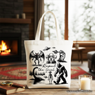 White tote bag featuring a humorous cryptid squad design with Bigfoot, Mothman, and alien illustrations, by OrnamentallyYou.