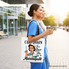 White Sassy Nursing School Tote Bag by OrnamentallyYou with humorous "Calm Down I've Done This" print on mannequin display