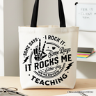 White tote bag by OrnamentallyYou featuring humorous "Some Days I Rock It, Some Days It Rocks Me" text, perfect for fun teachers.