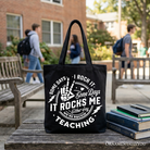 White tote bag with humorous "Some Days I Rock It, Some Days It Rocks Me" print, perfect for teachers or fun gift shoppers.