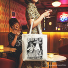 White canvas tote bag with UFO meme design, featuring a cynical woman and alien abduction comic artwork, perfect for casual shoppers.