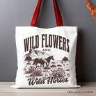 White canvas tote bag with wildflowers and wild horses print, featuring a retro western design, by OrnamentallyYou.