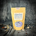 Small jar of Parlour of Wonders Absolute Power Bath Crystals with colorful crystals and a relaxing spa setting.