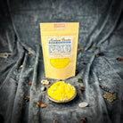 Small jar of Parlour of Wonders Bountiful Blessings Bath Crystals with colorful crystal granules for relaxing bath experience.