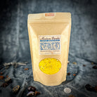 Small jar of Parlour of Wonders Bountiful Blessings Bath Crystals with colorful crystals and a decorative label.