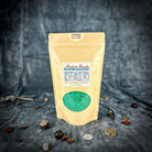 Small jar of Parlour of Wonders Good Luck Bath Crystals with colorful crystals for a relaxing bath experience.