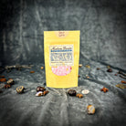Small jar of Parlour of Wonders Self Love Bath Crystals with pink and purple crystals for relaxing bath experience.