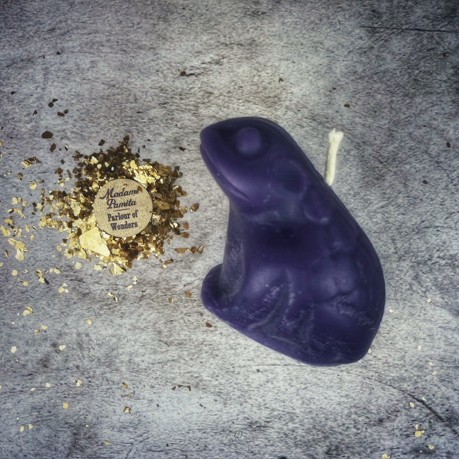 Black beeswax candle featuring a lucky money frog design from Parlour of Wonders, used for abundance and prosperity magic.