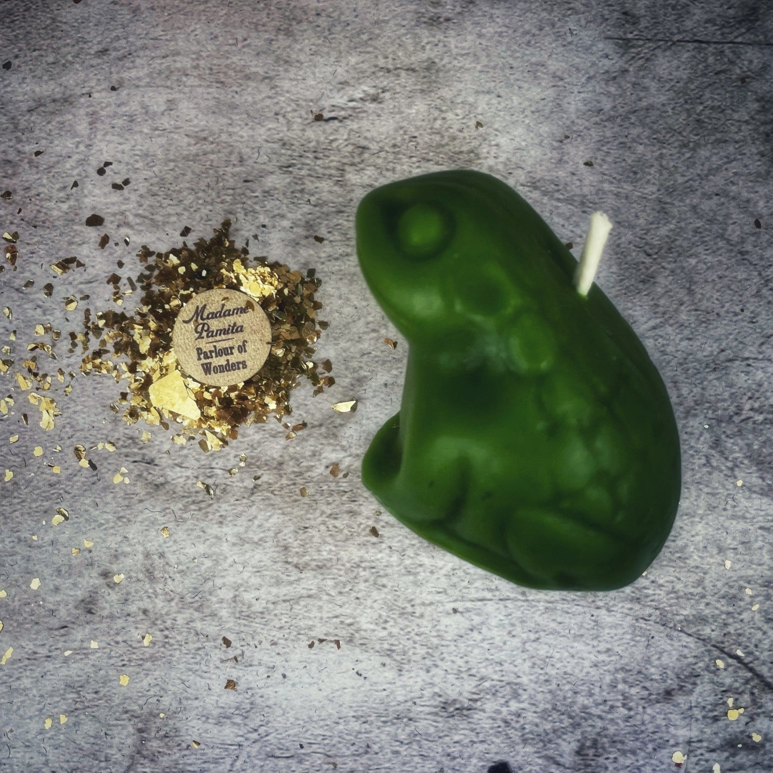 Black beeswax lucky money frog spell candle by Parlour of Wonders, designed for abundance and prosperity magic.