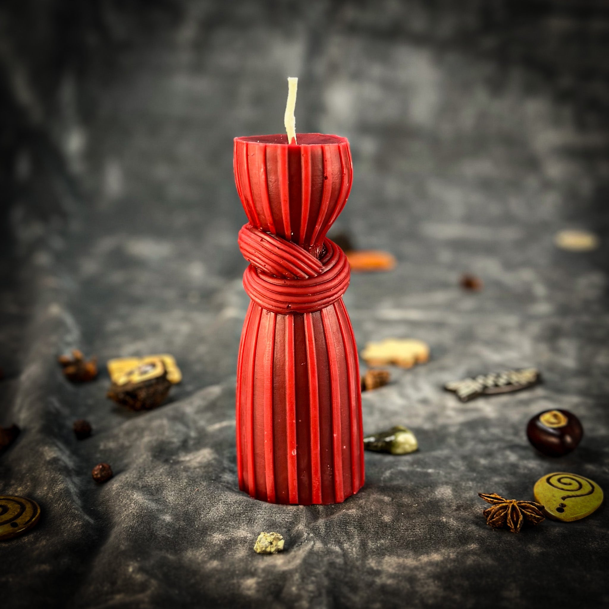 Black beeswax candle with intricate binding knot design, used for strengthening bonds and protection in spiritual rituals.