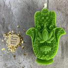 Blue beeswax Hamsa hand spell candle by Parlour of Wonders, featuring evil eye protection and blessing magic symbols.