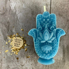 Blue beeswax Hamsa Hand spell candle by Parlour of Wonders for evil eye protection and blessing magic.
