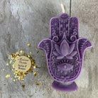 Blue beeswax Hamsa hand spell candle by Parlour of Wonders, used for evil eye protection and blessing magic.