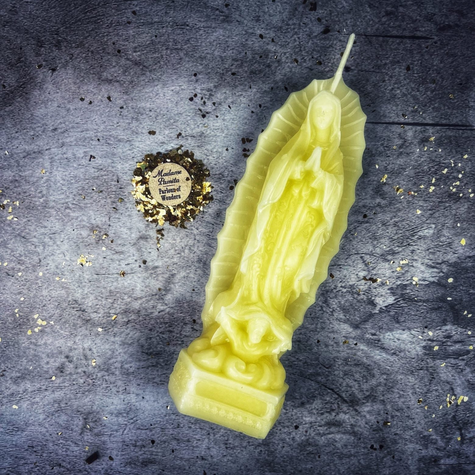 Blue beeswax candle with Nuestra Señora de Guadalupe image, symbolizing divine mother and miracles, by Parlour of Wonders.