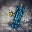 Blue beeswax candle featuring Nuestra Señora de Guadalupe design, symbolizing divine mother and miracles. Parlour of Wonders.