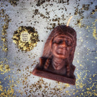 Beeswax Black Hawk Spell Candle by Parlour of Wonders, featuring a brown beeswax candle with spiritual and social justice magic symbols.