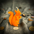 Brown beeswax squirrel candle with grounding design, symbolizing abundance, savings, and prosperity from Parlour of Wonders.