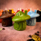 Green beeswax mushroom fairy hut candle by Parlour of Wonders, featuring detailed fairy home design for cozy magic ambiance.
