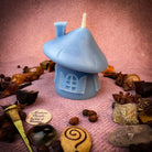Green beeswax mushroom fairy hut candle with detailed fairy home design, perfect for cozy magic and sanctuary blessings.