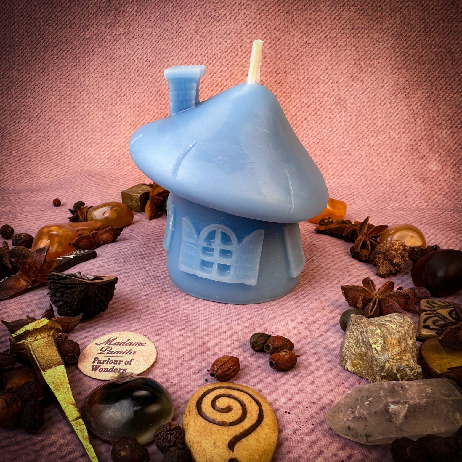 Green beeswax mushroom fairy hut candle with detailed fairy home design, perfect for cozy magic and sanctuary blessings.