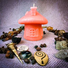 Green beeswax mushroom fairy hut candle by Parlour of Wonders, cozy fairy home with intricate mushroom design and magical details.