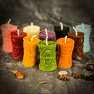 Green beeswax candle by Parlour of Wonders for debt collection and fair compensation, featuring a natural beeswax design.