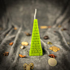 Green beeswax candle with all-seeing eye pyramid design, symbolizing abundance, prosperity, and intuition.