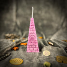 Green beeswax candle with an all-seeing eye pyramid design for abundance, prosperity, and intuition by Parlour of Wonders.