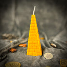 Green beeswax candle featuring an all-seeing eye pyramid design, symbolizing abundance, prosperity, and intuition.