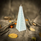 Green beeswax candle with all-seeing eye pyramid design for abundance, prosperity, and intuition by Parlour of Wonders.