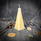 Green beeswax candle with all-seeing eye pyramid design for abundance, prosperity, and intuition from Parlour of Wonders.