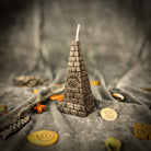 Green beeswax candle with an all-seeing eye pyramid design, symbolizing abundance, prosperity, and intuition.