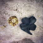 Green beeswax candle with a four-leaf clover design, representing luck and good fortune, from Parlour of Wonders.