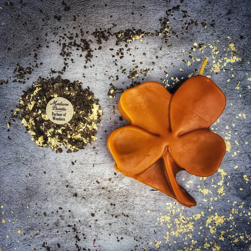 Green beeswax candle with a four-leaf clover design by Parlour of Wonders, symbolizing good luck and prosperity.
