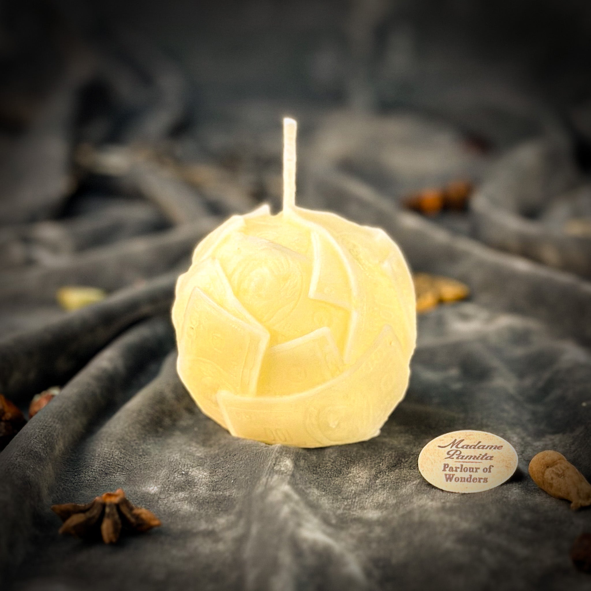 Green beeswax candle with rolled dough design by Parlour of Wonders, symbolizing wealth, abundance, and luxury.