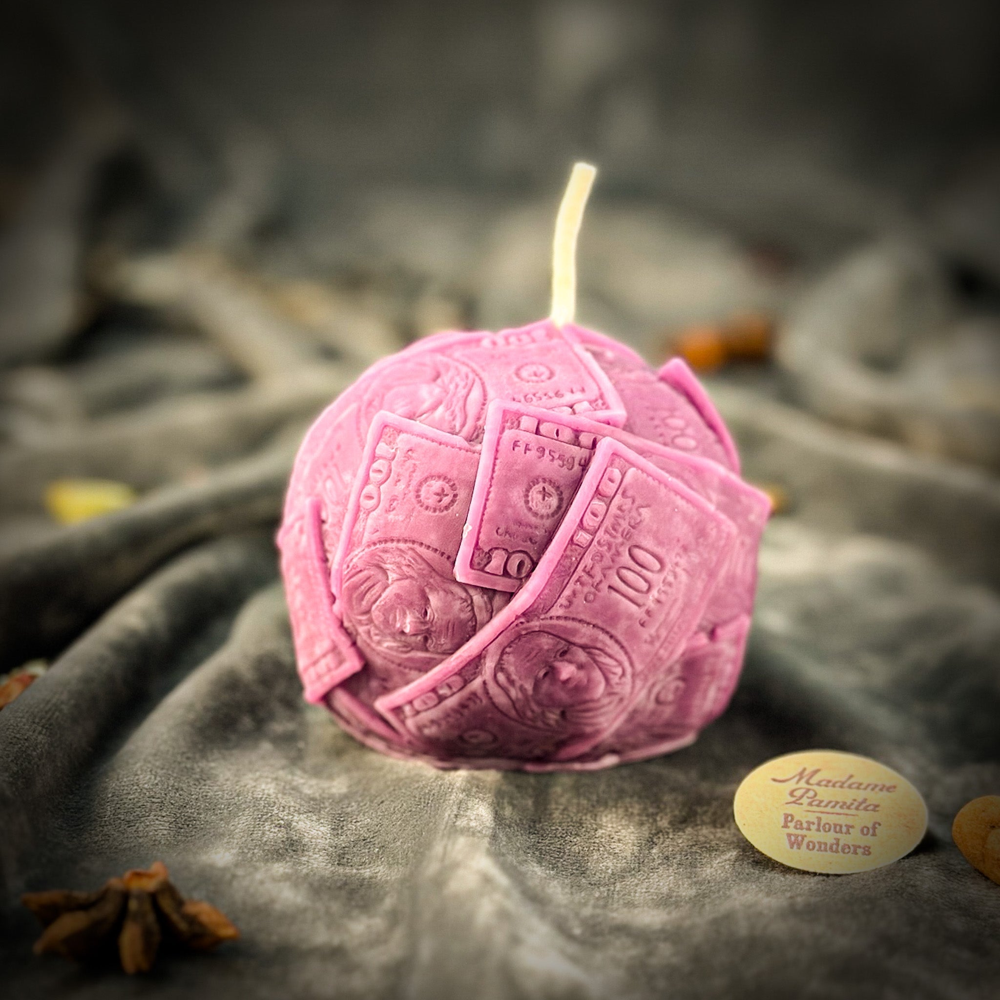 Green beeswax candle shaped like rolling in dough spell, symbolizing wealth and abundance, from Parlour of Wonders.