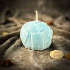 Green beeswax candle by Parlour of Wonders featuring a rolling in dough design, symbolizing wealth and abundance.