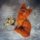 Orange beeswax candle by Parlour of Wonders, designed for quick results and cunning magic with a fox spell theme.