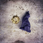 Orange beeswax candle featuring a howling wolf design, used for courage and authentic voice magic by Parlour of Wonders.