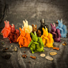 Orange beeswax rabbit spell candle by Parlour of Wonders, featuring a rabbit design symbolizing good luck and new beginnings.
