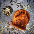 Beeswax Lucky Horseshoe Spell Candle by Parlour of Wonders, orange beeswax candle symbolizing luck and power magic.