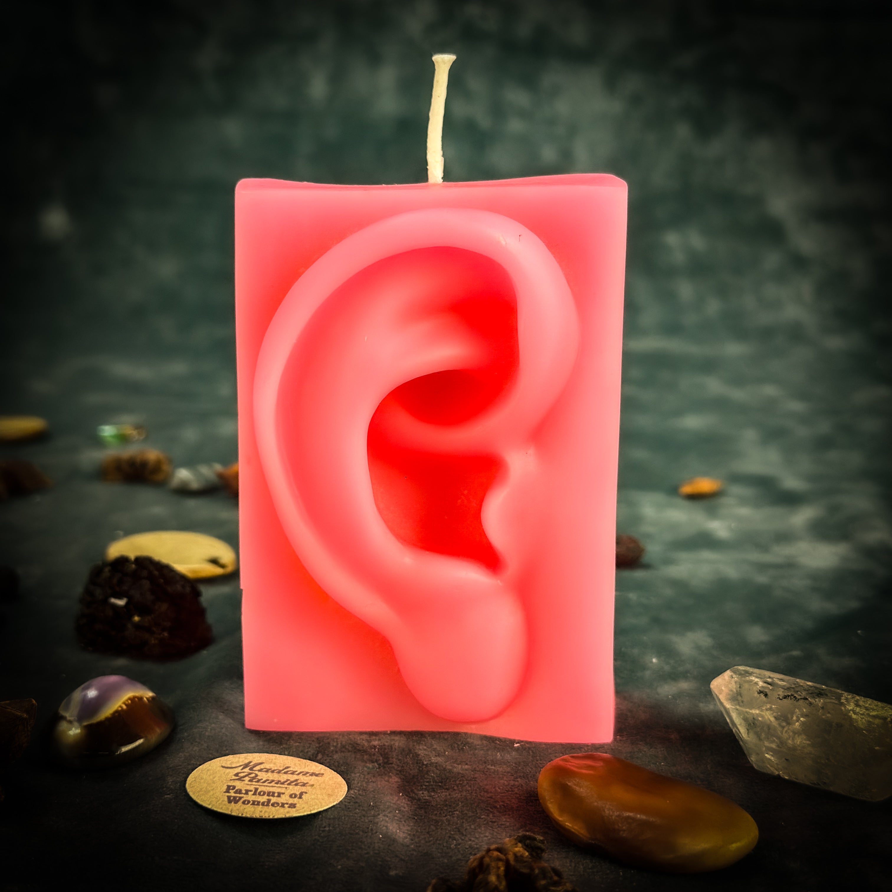 Orange beeswax candle with ear-shaped design for healing, clairaudience, and being heard, from Parlour of Wonders.