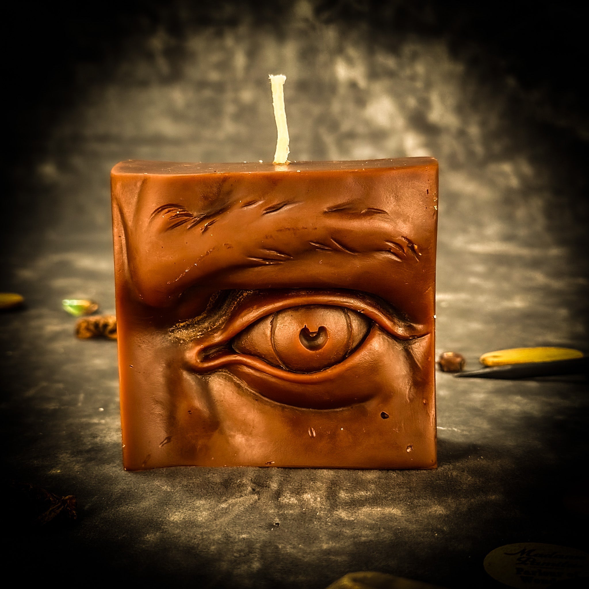 Beeswax Ex-Voto Eye Spell Candle by Parlour of Wonders for vision, clairvoyance, and being seen, with orange wax and eye symbol.
