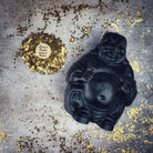 Beeswax Laughing Buddha spell candle by Parlour of Wonders featuring orange beeswax for wealth, luck, and prosperity magic.