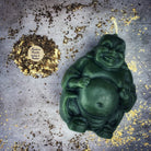 Beeswax Laughing Buddha spell candle by Parlour of Wonders, orange wax for wealth, luck, and prosperity magic.