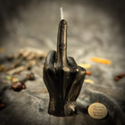 Orange beeswax candle by Parlour of Wonders featuring a middle finger design for banishing, boundaries, and empowerment spells.