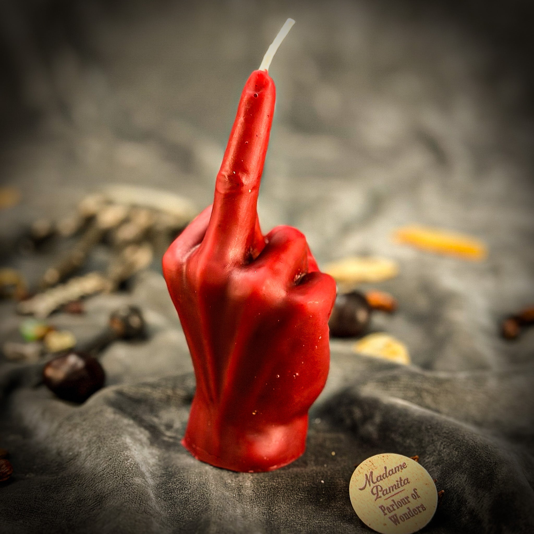 Beeswax middle finger spell candle by Parlour of Wonders with orange wax, used for banishing, boundaries, and empowerment.