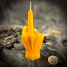 Beeswax middle finger spell candle by Parlour of Wonders with orange wax, symbolizing banishing, boundaries, and empowerment.